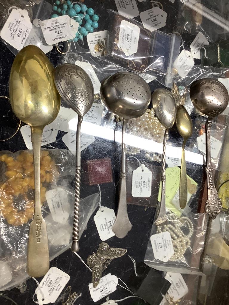 A late 19th century Russian 84 zolotnik tea strainer, a Russian cake slice and sugar sifter and a group of other Russian flatware including enamelled teaspoons